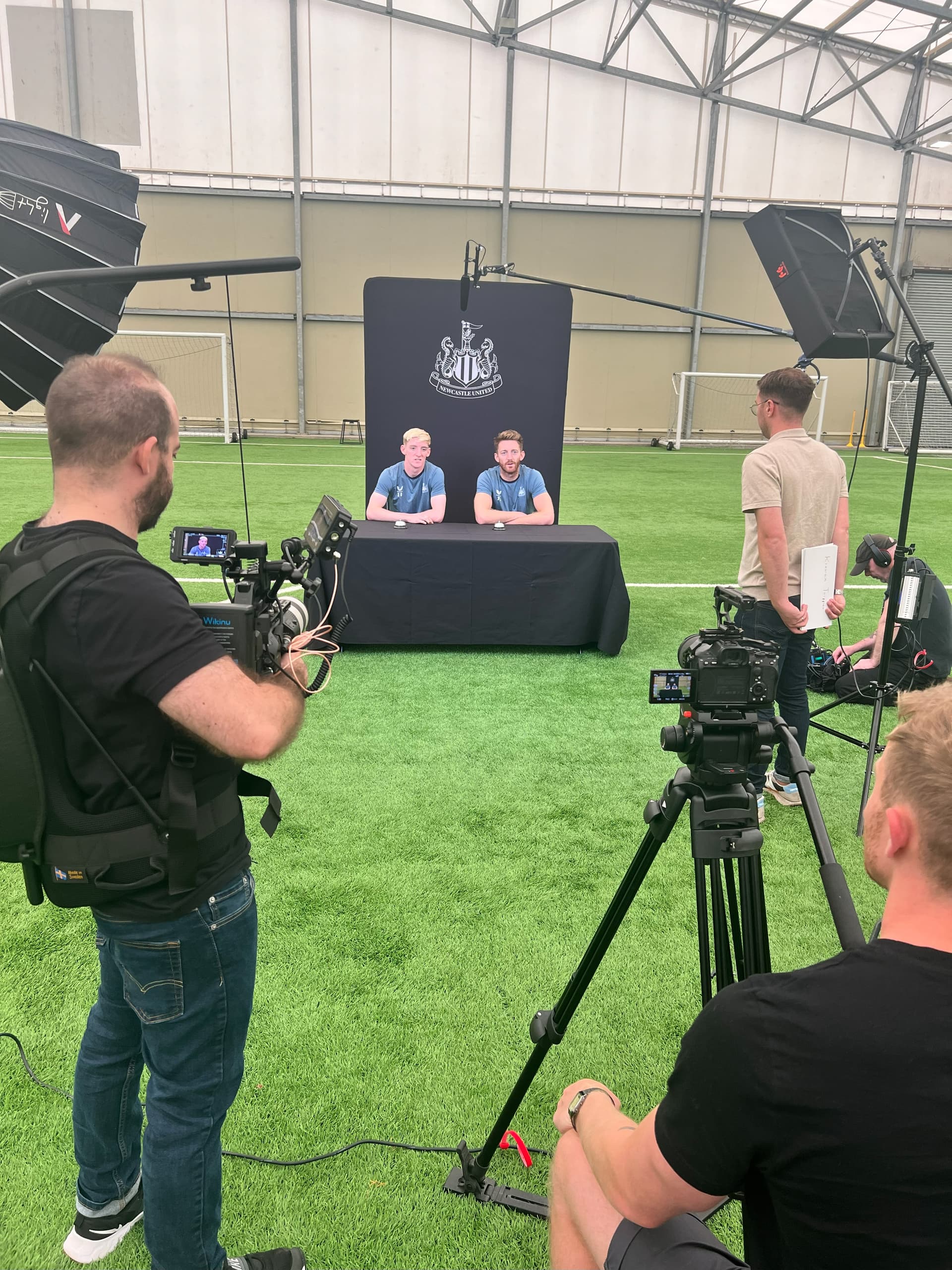 Multi-camera video production setup filming Newcastle United press conference - professional broadcast quality